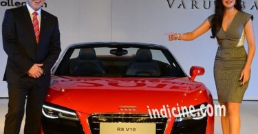 Katrina Kaif posing with a red Audi